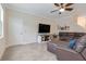 Cozy living room with leather sectional, wall decor, and large screen television at 1472 Rushing Rapids Way, Winter Springs, FL 32708