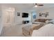 Open living room with a plush sectional, a large TV, and neutral carpet at 1472 Rushing Rapids Way, Winter Springs, FL 32708