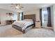 Spacious main bedroom with tufted headboard, large windows, and modern ceiling fan at 1472 Rushing Rapids Way, Winter Springs, FL 32708