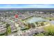 Aerial view of neighborhood with a scenic lake, mature trees, and well-maintained homes at 1472 Rushing Rapids Way, Winter Springs, FL 32708