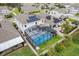 Aerial view of a home featuring a screened-in pool, solar panels, and a well-maintained yard at 1472 Rushing Rapids Way, Winter Springs, FL 32708