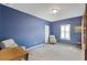 Neutral carpeted bedroom features blue walls, white trim, and shuttered window at 15143 Ovation Dr, Winter Garden, FL 34787