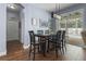 Cozy dining area with modern light fixture and an expansive sliding glass door, leading to outdoor pool area at 15143 Ovation Dr, Winter Garden, FL 34787