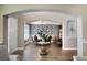 View from the living room into a formal dining room with wood floors and an elegant glass-top table at 15143 Ovation Dr, Winter Garden, FL 34787