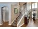 Welcoming entryway with staircase, high ceilings, wood floors, and arched doorways at 15143 Ovation Dr, Winter Garden, FL 34787