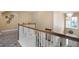 Hallway area showcasing the staircase with wooden rails and decorative carpet at 15143 Ovation Dr, Winter Garden, FL 34787