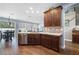 Open-concept kitchen with wood floors, stainless steel dishwasher, and cabinetry next to an adjacent dining area at 15143 Ovation Dr, Winter Garden, FL 34787