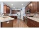 Spacious kitchen featuring stainless steel appliances, wooden cabinets, tile backsplash, and granite countertops at 15143 Ovation Dr, Winter Garden, FL 34787