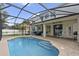 Inviting screened pool with patio, comfortable seating, and lush backyard; ideal for relaxation at 15143 Ovation Dr, Winter Garden, FL 34787