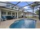 Screened-in patio boasts a pool, palm tree, and a seating area with grill at 15143 Ovation Dr, Winter Garden, FL 34787