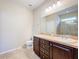 Bathroom featuring a spacious vanity, toilet, and enclosed shower, providing essential amenities at 20945 Oldenburg Loop, Mount Dora, FL 32757