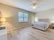 Cozy bedroom featuring a large window, ceiling fan, and ample space, creating a relaxing retreat at 20945 Oldenburg Loop, Mount Dora, FL 32757