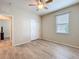 Bright bedroom with wood floors, double door closet, ceiling fan and a window at 20945 Oldenburg Loop, Mount Dora, FL 32757