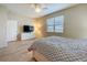 Bright bedroom featuring a neutral color scheme, ceiling fan, and plenty of room for relaxation and personalization at 20945 Oldenburg Loop, Mount Dora, FL 32757