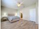 Well-lit bedroom featuring a ceiling fan, neutral paint, and sleek wood-look flooring at 20945 Oldenburg Loop, Mount Dora, FL 32757