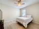 Cozy bedroom with wood floors, a ceiling fan, and natural light from a window at 20945 Oldenburg Loop, Mount Dora, FL 32757