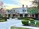 Clubhouse exterior showcasing detailed architecture, a metal roof, brick accents, and manicured landscaping at 20945 Oldenburg Loop, Mount Dora, FL 32757