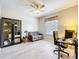 Living area with neutral paint, a ceiling fan, a comfortable sofa, and a window, creating a serene living space at 20945 Oldenburg Loop, Mount Dora, FL 32757