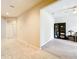 Open living room featuring tile flooring, neutral walls, and an open concept layout with black display cabinet at 20945 Oldenburg Loop, Mount Dora, FL 32757