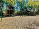 Community playground with swings, shade, and wood chip ground cover at 20945 Oldenburg Loop, Mount Dora, FL 32757