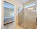 Enclosed shower with neutral tile and modern fixtures, conveniently located near the bedroom at 20945 Oldenburg Loop, Mount Dora, FL 32757