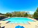 Large swimming pool surrounded by trees with blue umbrellas at 20945 Oldenburg Loop, Mount Dora, FL 32757