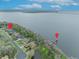 Expansive aerial view of neighborhood waterfront homes and docks, demonstrating the community's scenic location near a lake at 210 Torcaso Ct, Winter Springs, FL 32708