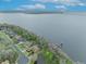 High aerial view of waterfront homes, showcasing the neighborhood's proximity to a lake with bridge in the distance at 210 Torcaso Ct, Winter Springs, FL 32708