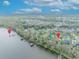 Wide aerial shot of houses located near a lake with docks, showcasing the community's access to waterfront amenities at 210 Torcaso Ct, Winter Springs, FL 32708