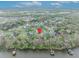 Scenic aerial view of homes nestled amongst trees and near a lake, illustrating a peaceful neighborhood setting at 210 Torcaso Ct, Winter Springs, FL 32708