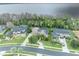 Aerial view highlighting the street, lawns, landscaping and screened in pools of waterfront homes, demonstrating an upscale community at 210 Torcaso Ct, Winter Springs, FL 32708