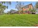 Sprawling backyard with lush green grass and screened pool enclosure at 210 Torcaso Ct, Winter Springs, FL 32708