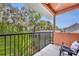 This balcony boasts views of lush landscaping and a pool, creating a serene outdoor escape at 210 Torcaso Ct, Winter Springs, FL 32708