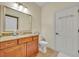 Well-lit bathroom with a granite countertop vanity, ceramic tile flooring, and a separate toilet area at 210 Torcaso Ct, Winter Springs, FL 32708