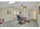 Cozy carpeted bedroom with ceiling fan, skylight, desk, and access to a balcony at 210 Torcaso Ct, Winter Springs, FL 32708