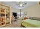 Comfortable bedroom features built-in shelving, a ceiling fan, and a sunlit window nook at 210 Torcaso Ct, Winter Springs, FL 32708