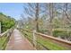 Scenic boardwalk through lush greenery and trees, offering peaceful nature walks and access to the lake at 210 Torcaso Ct, Winter Springs, FL 32708