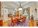 Formal dining room with a chandelier, large window, and elegant decor at 210 Torcaso Ct, Winter Springs, FL 32708