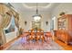 Traditional dining room with a large table, elegant chandelier, and classic furnishings at 210 Torcaso Ct, Winter Springs, FL 32708