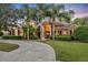 Stunning home exterior featuring a circular driveway and mature landscaping at 210 Torcaso Ct, Winter Springs, FL 32708