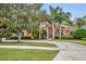 Stunning home exterior featuring a circular driveway and mature landscaping at 210 Torcaso Ct, Winter Springs, FL 32708