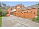 A three-car garage and exterior view of the property at 210 Torcaso Ct, Winter Springs, FL 32708