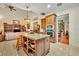 Open kitchen featuring granite countertops, an island with shelving, and stainless steel appliances at 210 Torcaso Ct, Winter Springs, FL 32708