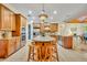 Well-lit kitchen featuring a large center island, stainless steel appliances, and custom cabinetry at 210 Torcaso Ct, Winter Springs, FL 32708