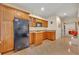 Kitchenette with wood cabinets, sink, microwave and full-size refrigerator at 210 Torcaso Ct, Winter Springs, FL 32708