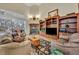 Comfortable living room featuring a fireplace, built-in bookshelves, and plush seating at 210 Torcaso Ct, Winter Springs, FL 32708