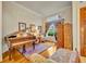 Cozy living room with a grand piano, large window, and elegant decor at 210 Torcaso Ct, Winter Springs, FL 32708