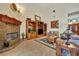 Spacious living room with a fireplace, custom wooden bookshelves, and tile flooring at 210 Torcaso Ct, Winter Springs, FL 32708