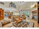 Spacious living room with high ceilings, a fireplace, and an open layout connecting to the kitchen at 210 Torcaso Ct, Winter Springs, FL 32708