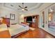 Stylish main bedroom featuring a large bed, hardwood floors, and access to the outside at 210 Torcaso Ct, Winter Springs, FL 32708